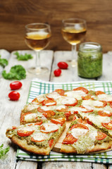tomato mozzarella kale pesto pizza