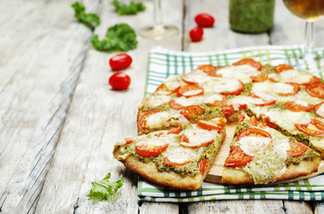tomato mozzarella kale pesto pizza