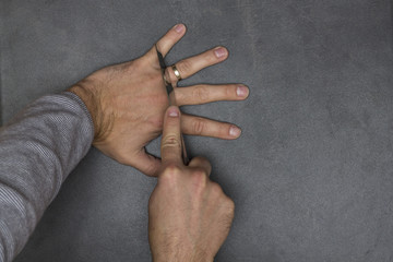 man cuts knife finger with wedding ring