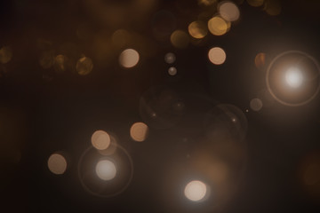 Glitter vintage lights background. dark gold and black. defocused