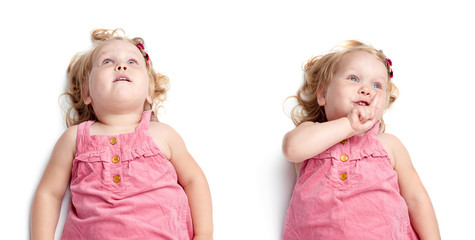 Young little girl lying over isolated white background