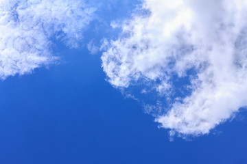 Blue sky background with white clouds. The vast blue sky and clouds sky on sunny day. White fluffy clouds in the blue sky.