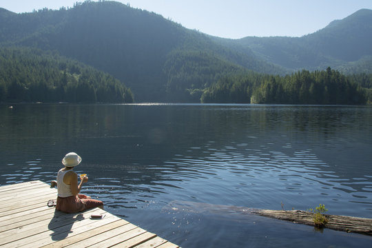 Woamn enjoying morning tea on Klein Lake near Egmont, ,  Sunshine Coast, British Columbia, CanadaBritish Columbia, Canada