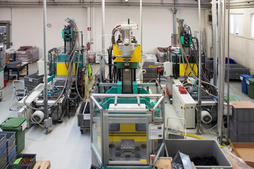 Injection molding machines in a large factory - obrazy, fototapety, plakaty