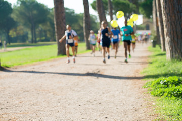 runners in marathon in a park abstract, blurry
