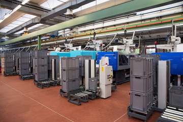 Injection molding machines in a large factory - obrazy, fototapety, plakaty