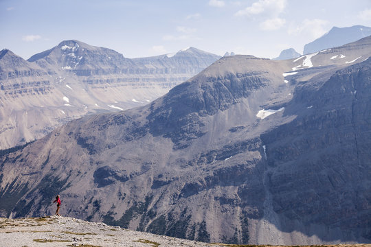 A young woman stands atop Parker Ridge, Banff National Park, Alberta, Canada