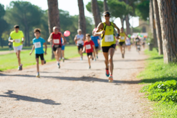 runners in marathon in a park abstract, blurry
