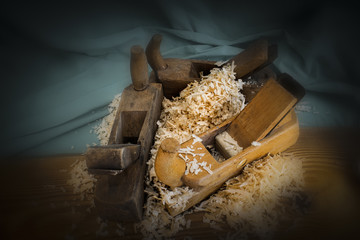 Pile of sawdust with three plane hand tools