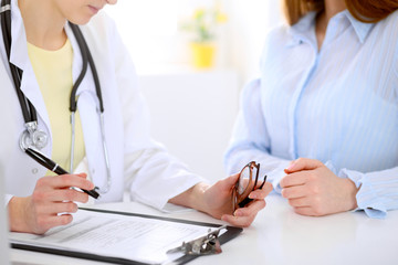 Doctor and patient are discussing something, just hands at the table