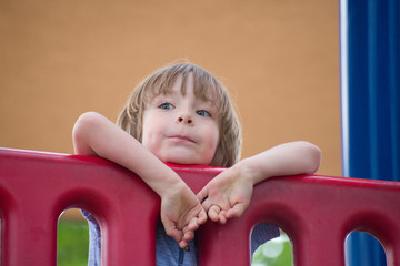 Adorable little boy playing outside on playground