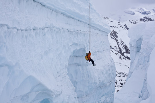 A man practicing crevasse rescue skills while on a ski mountaineering course, Ice fall Lodge, Golden, British Columbia, Canada
