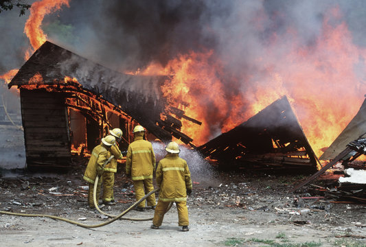Firemen douse burning building, British Columbia, Canada.