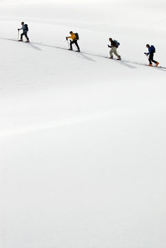 Ski group crossing snow slope, British Columbia, Canada