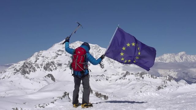 French mountaineer celebrates on mountain peaks.