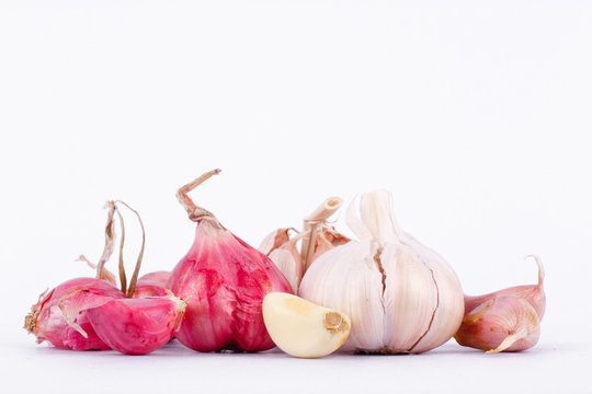 Shallots (Red Onion) and Garlics are popular ingredients in cooking on the white background isolated

