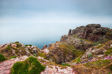 Rocks and see in the haze in Cap Frehel, Brittany, France