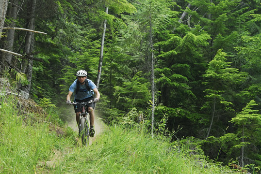 Man bikes the Seven Summits trail, Rossland, British Columbia, Canada.