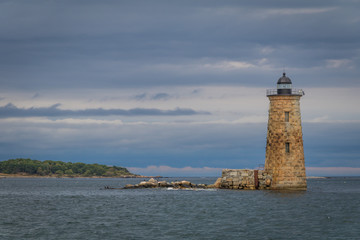 Fototapeta na wymiar Whaleback Lighthouse in Kittery, Maine, on a cloudy foggy day in early Fall