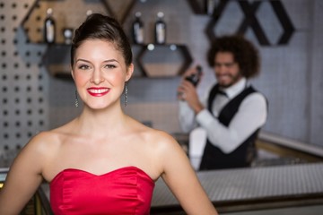 Portrait of beautiful woman standing in bar