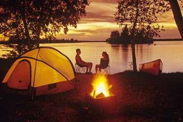 Young couple camping, Otter Falls, Whiteshell Provincial Park, Manitoba, Canada.