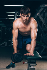 Fototapeta na wymiar sport, fitness, lifestyle and people concept - flexing muscles with dumbbells in gym