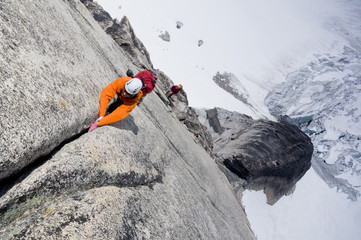A pair of rock climbers ascend Surf's Up, a route on Snowpatch Spire in the Bugaboos, British Columbia