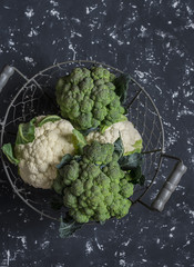 Fresh broccoli and cauliflower on a dark background.