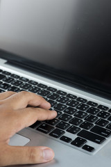 Close up of hand typing on white keyboard