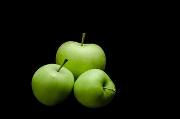Green apples with black background