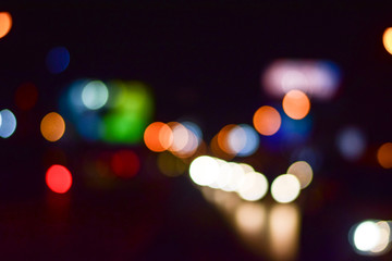 Abstract blurry traffic road bokeh light view from inside a car