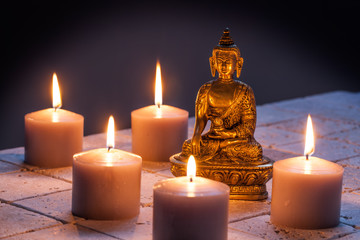 Fototapeta na wymiar concept of mindfulness and buddhism with Buddha and lighted candles