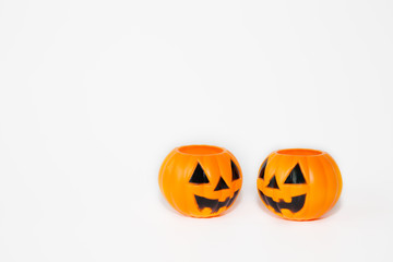 Two orange jack-o-lantern bucket pumpkins in white isolated background