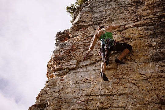 Woman climbing rock, Castle Mountain, Canada