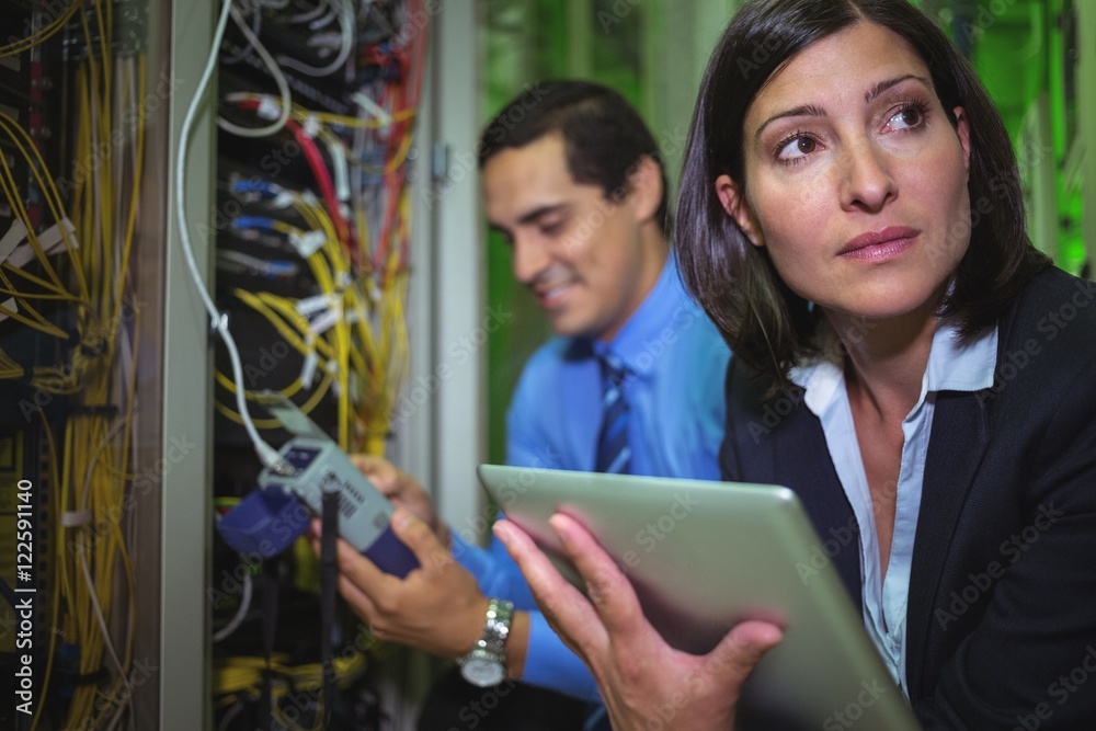 Poster Technicians analyzing rack mounted server