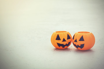 Orange jack-o-lantern bucket pumpkins on grungy background - vintage tone