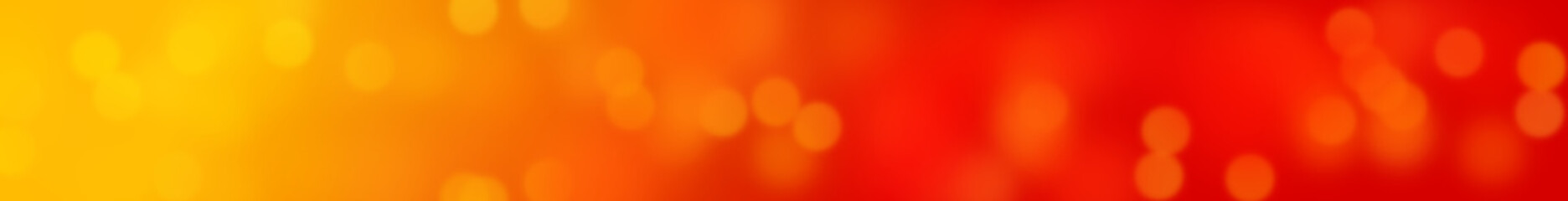 bokeh effect banner background in shades of soft yellow, red and orange