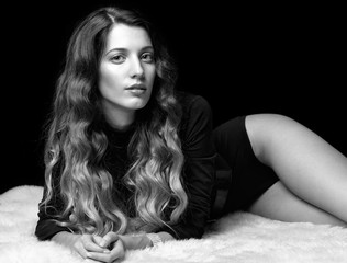 Portrait of beautiful caucasian model posing on black 