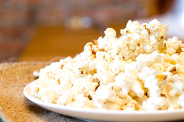Selected focus of a popcorn on white plate