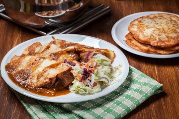 Potato pancakes with meat stew served