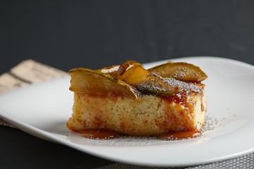 Piece of pear pie with poppy and sauce.