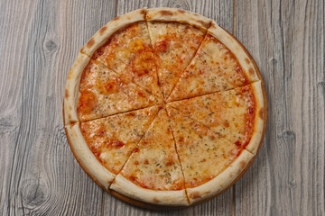 Pizza margherita cuted on pieces. Top view.