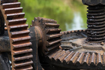 close up rusty and oily water gate gear.