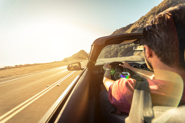 Cool man driving a sport convertible car in California