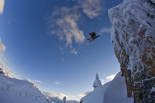 A skier catching big air in the backcountry of Kicking Horse, Golden, British Columbia, Canada