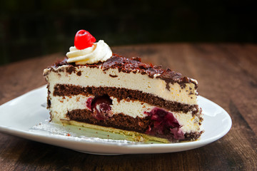 Black Forest cake with chocolate and cherry brandy, dark background