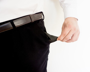 Business man showing his empty pockets on white background.