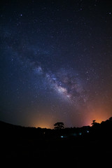 Fototapeta na wymiar Milky Way Galaxy and Silhouette of Tree with cloud.Long exposure