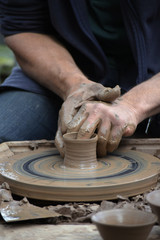 potter creating a ceramic of clay on the potter's wheel in the pottery