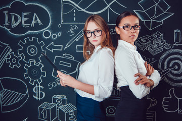 Europeans and Asian business women with glasses standing on a dark background